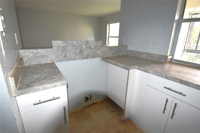 4231 NW 19th St Unit 256, Lauderhill, FL 33313 - kitchen featuring white cabinets and light tile patterned floors