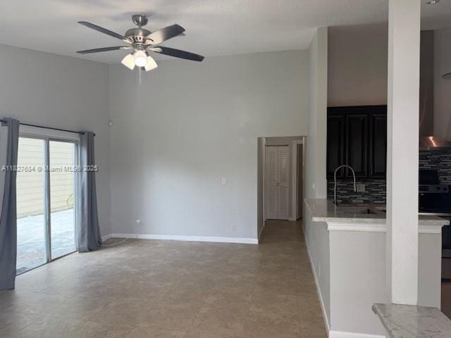 11224 Sacco Dr, Boca Raton, FL 33428 - spare room with ceiling fan, a high ceiling, and light tile patterned flooring