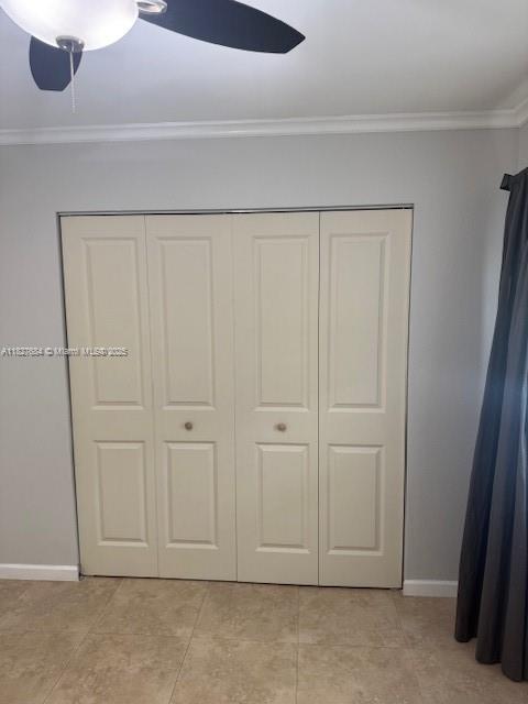 11224 Sacco Dr, Boca Raton, FL 33428 - unfurnished bedroom featuring ornamental molding, a closet, light tile patterned floors, and a ceiling fan