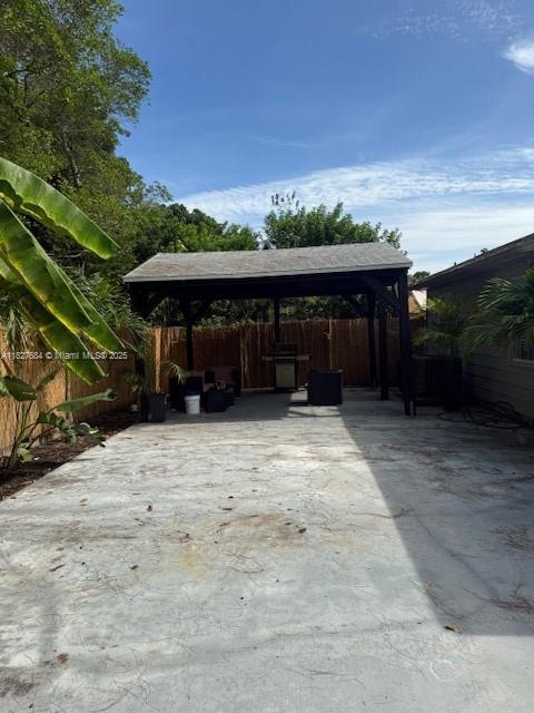 11224 Sacco Dr, Boca Raton, FL 33428 - fenced backyard with a gazebo, a detached carport, a patio area, and concrete driveway