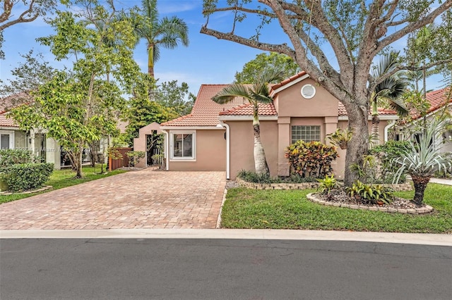 321 NW 100th Ave, Plantation, FL 33324 - mediterranean / spanish-style home with stucco siding, a tiled roof, and decorative driveway