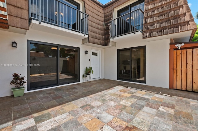 9112A SW 20th St, Davie, FL 33324 - property entrance featuring mansard roof, stucco siding, and a balcony