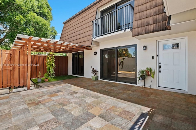 9112A SW 20th St, Davie, FL 33324 - property entrance featuring mansard roof, stucco siding, a balcony, a patio, and a pergola