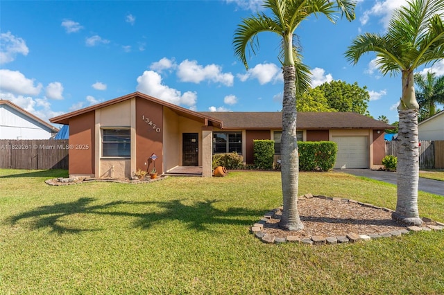 13420 SW 53rd St, Miami, FL 33175 - view of front of property with stucco siding, asphalt driveway, and an attached garage