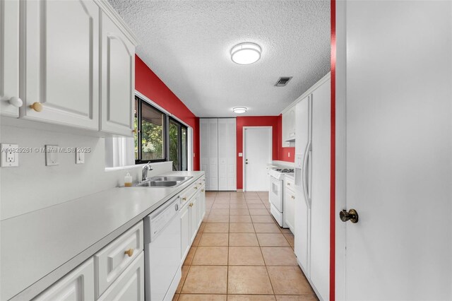 13420 SW 53rd St, Miami, FL 33175 - kitchen featuring white appliances, a textured ceiling, light countertops, and white cabinetry