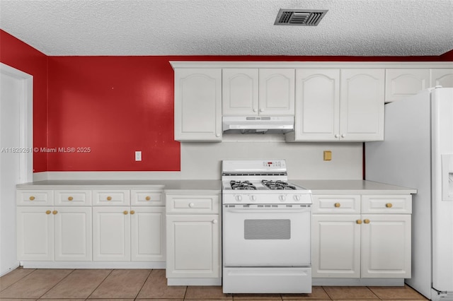 13420 SW 53rd St, Miami, FL 33175 - kitchen featuring white appliances, under cabinet range hood, white cabinets, a textured ceiling, and light countertops