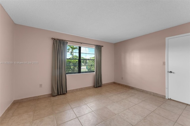 13420 SW 53rd St, Miami, FL 33175 - spare room with a textured ceiling and light tile patterned floors