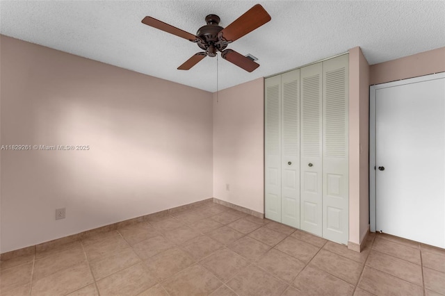 13420 SW 53rd St, Miami, FL 33175 - unfurnished bedroom featuring a closet, light tile patterned floors, a textured ceiling, and ceiling fan