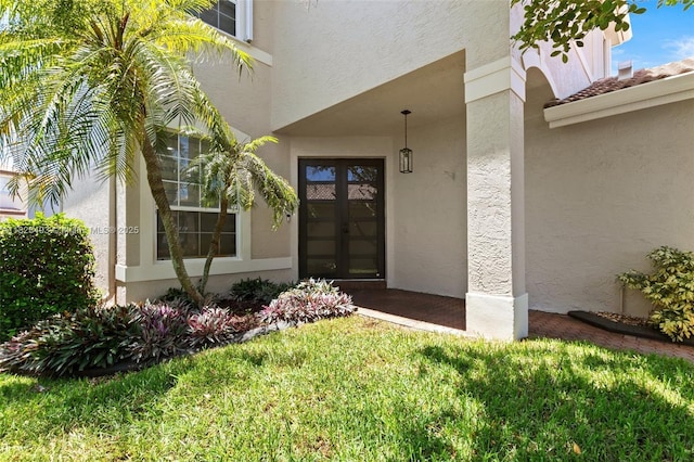 2406 SW 162nd Ter, Miramar, FL 33027 - doorway to property featuring stucco siding, french doors, and a lawn