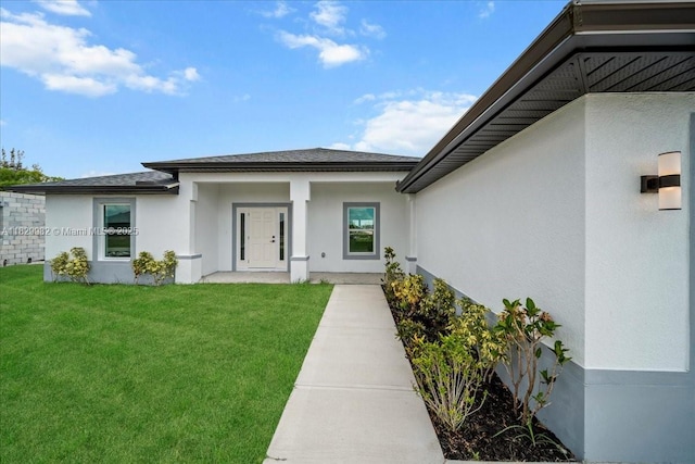 1301 NE 36th Ln, Cape Coral, FL 33909 - property entrance featuring a lawn, stucco siding, and a shingled roof