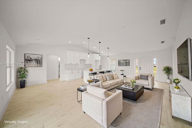 1301 NE 36th Ln, Cape Coral, FL 33909 - living room featuring vaulted ceiling, light wood-style floors, and recessed lighting