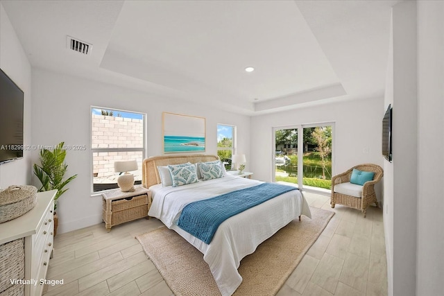 1301 NE 36th Ln, Cape Coral, FL 33909 - bedroom featuring a raised ceiling, light wood finished floors, and recessed lighting