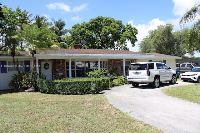 8200 SW 164th St, Palmetto Bay, FL 33157 - ranch-style house featuring a front yard, brick siding, and concrete driveway