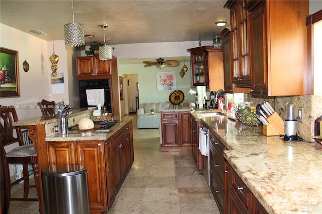 8200 SW 164th St, Palmetto Bay, FL 33157 - kitchen with oven, a breakfast bar, ceiling fan, light stone counters, and backsplash