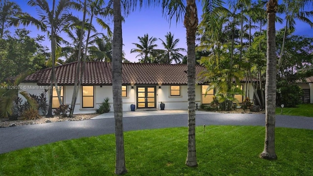 18301 SW 86th Ave, Palmetto Bay, FL 33157 - view of front of property featuring a tiled roof, french doors, a front yard, and stucco siding