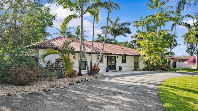 18301 SW 86th Ave, Palmetto Bay, FL 33157 - mediterranean / spanish house with a tiled roof, stucco siding, and asphalt driveway