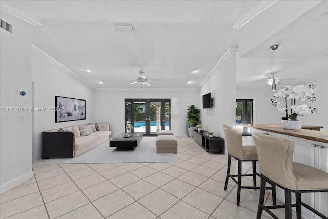 18301 SW 86th Ave, Palmetto Bay, FL 33157 - living area with a ceiling fan, french doors, light tile patterned floors, crown molding, and a textured ceiling