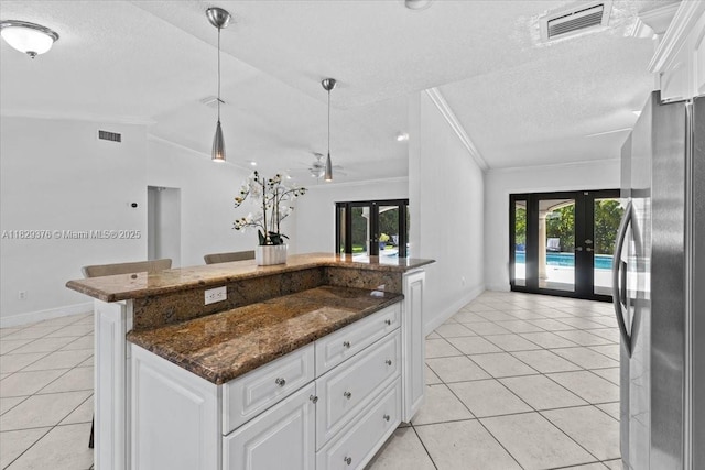 18301 SW 86th Ave, Palmetto Bay, FL 33157 - kitchen with freestanding refrigerator, french doors, light tile patterned flooring, vaulted ceiling, and ornamental molding