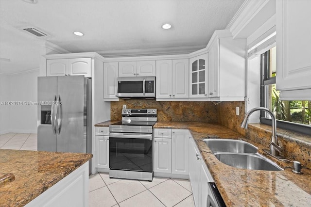 18301 SW 86th Ave, Palmetto Bay, FL 33157 - kitchen with appliances with stainless steel finishes, light tile patterned flooring, ornamental molding, white cabinets, and recessed lighting