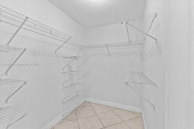 18301 SW 86th Ave, Palmetto Bay, FL 33157 - spacious closet featuring light tile patterned floors