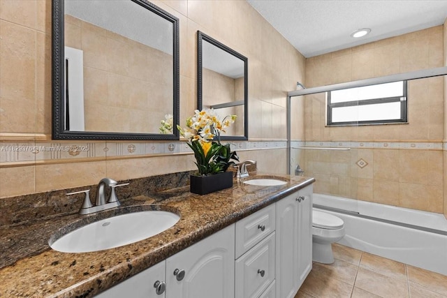 18301 SW 86th Ave, Palmetto Bay, FL 33157 - bathroom featuring enclosed tub / shower combo, double vanity, tile walls, tile patterned floors, and a textured ceiling