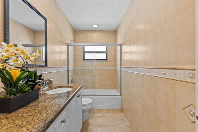 18301 SW 86th Ave, Palmetto Bay, FL 33157 - bathroom featuring vanity, a textured ceiling, enclosed tub / shower combo, tile walls, and tile patterned flooring