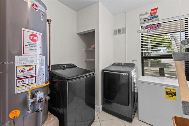 18301 SW 86th Ave, Palmetto Bay, FL 33157 - laundry room featuring water heater, separate washer and dryer, and light tile patterned floors