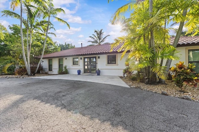 18301 SW 86th Ave, Palmetto Bay, FL 33157 - view of front of property featuring a tile roof and stucco siding