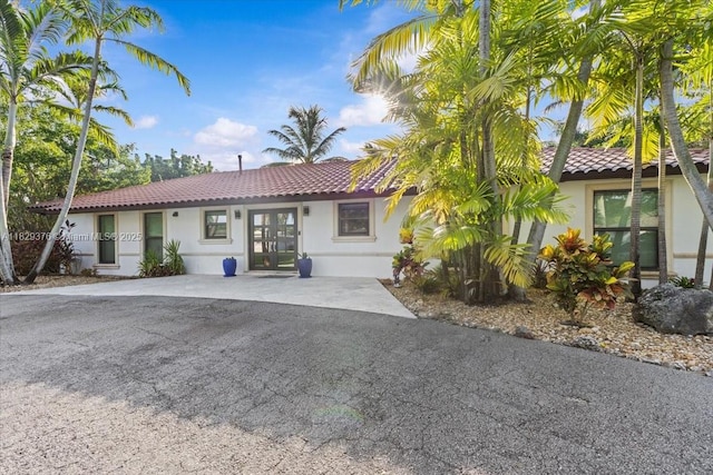 18301 SW 86th Ave, Palmetto Bay, FL 33157 - view of front of house featuring stucco siding, a tile roof, and french doors
