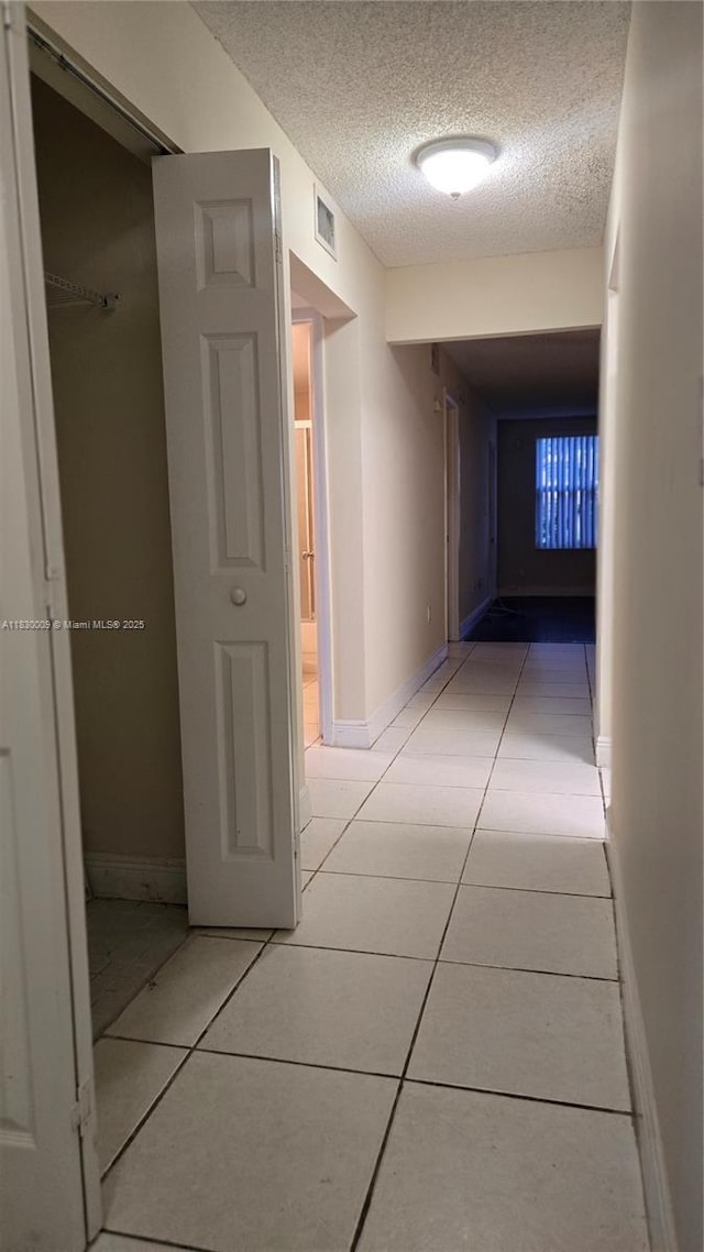 7500 NW 17th St Unit 101, Plantation, FL 33313 - hall with light tile patterned floors and a textured ceiling