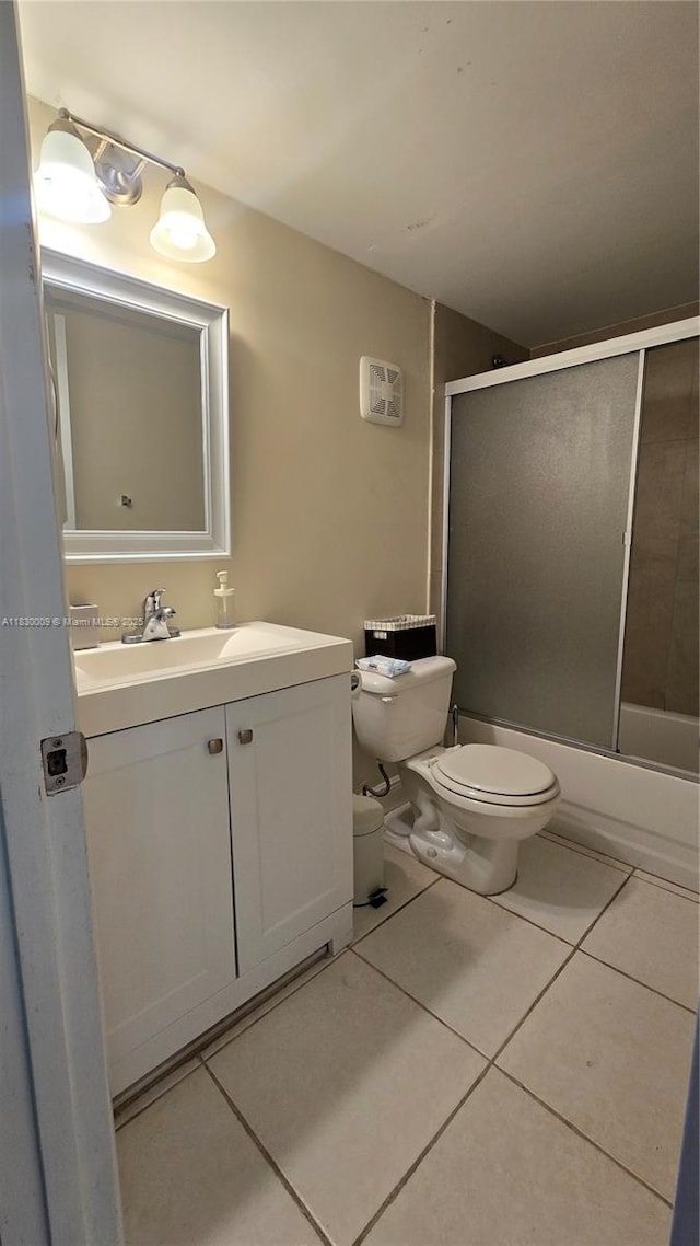 7500 NW 17th St Unit 101, Plantation, FL 33313 - full bathroom with vanity, tile patterned floors, and bath / shower combo with glass door