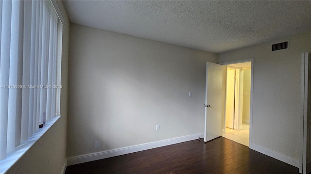 7500 NW 17th St Unit 101, Plantation, FL 33313 - unfurnished bedroom with wood finished floors and a textured ceiling