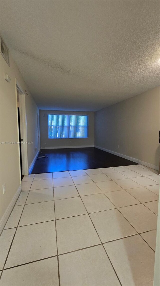7500 NW 17th St Unit 101, Plantation, FL 33313 - tiled spare room featuring a textured ceiling and baseboards