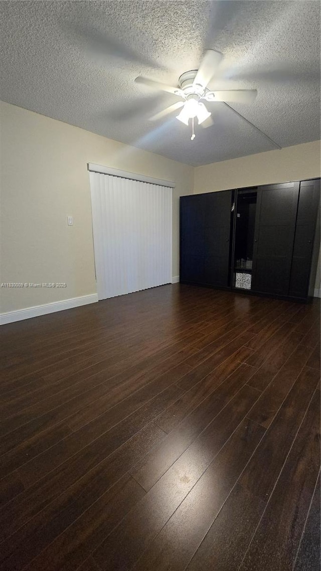 7500 NW 17th St Unit 101, Plantation, FL 33313 - unfurnished bedroom featuring dark wood-type flooring, a textured ceiling, and a ceiling fan