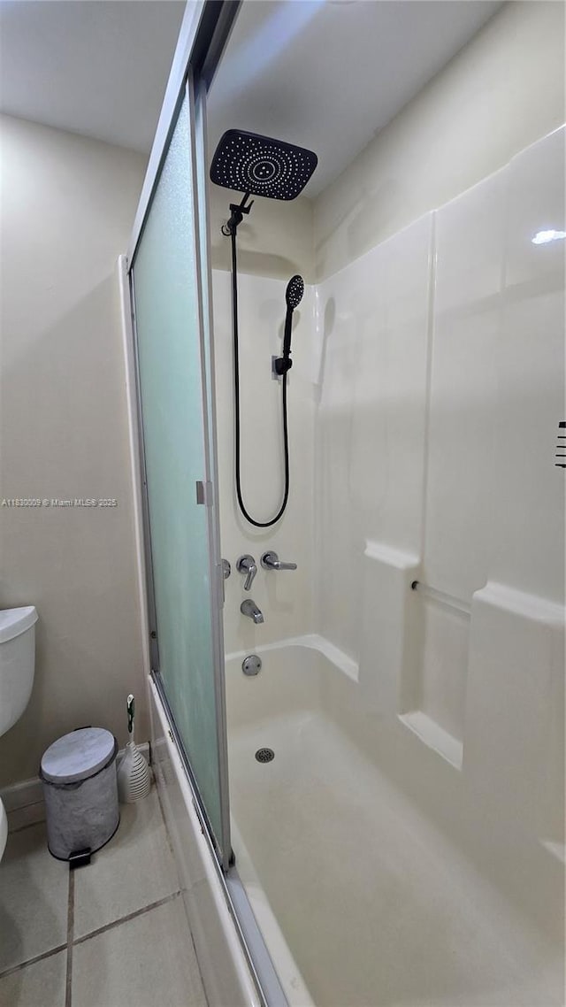 7500 NW 17th St Unit 101, Plantation, FL 33313 - bathroom with tile patterned flooring and combined bath / shower with glass door