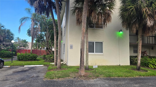 7500 NW 17th St Unit 101, Plantation, FL 33313 - view of side of home with stucco siding and uncovered parking