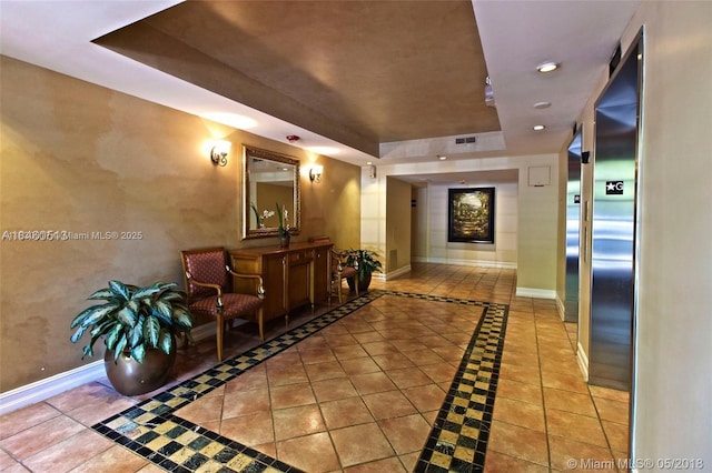 19655 E Country Club Dr Unit 6108, Aventura, FL 33180 - corridor featuring a tray ceiling, inlaid floor details, tile patterned flooring, and recessed lighting