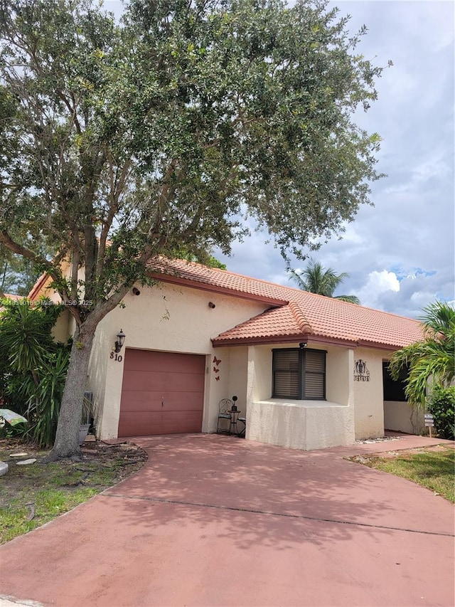 810 SW 113th Ter, Pembroke Pines, FL 33025 - mediterranean / spanish-style home featuring concrete driveway, a tile roof, a garage, and stucco siding