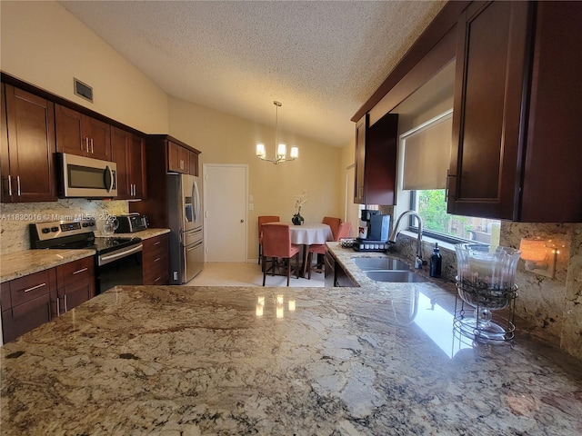810 SW 113th Ter, Pembroke Pines, FL 33025 - kitchen with appliances with stainless steel finishes, lofted ceiling, a chandelier, light stone countertops, and backsplash