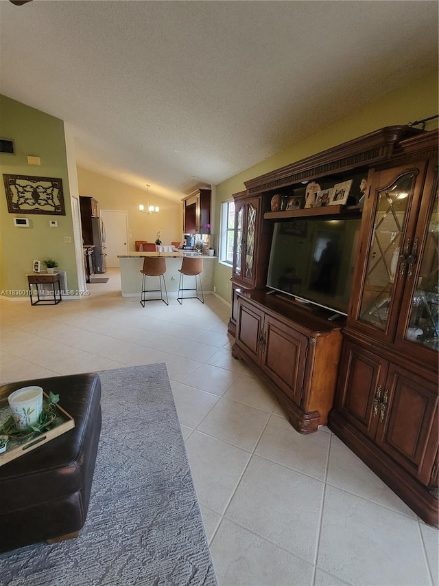 810 SW 113th Ter, Pembroke Pines, FL 33025 - living room with vaulted ceiling, light tile patterned flooring, a textured ceiling, and a chandelier
