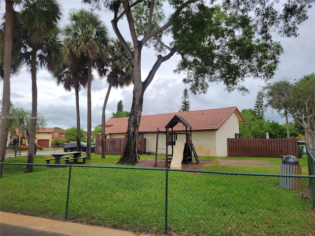 810 SW 113th Ter, Pembroke Pines, FL 33025 - view of front of property with a playground, stucco siding, and a tiled roof