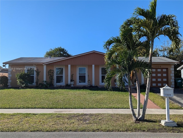 11024 SW 157th Ter, Miami, FL 33157 - view of front of property with an attached garage, a front lawn, and driveway