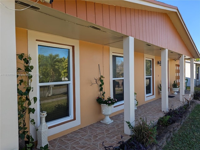 11024 SW 157th Ter, Miami, FL 33157 - doorway to property featuring stucco siding and a porch