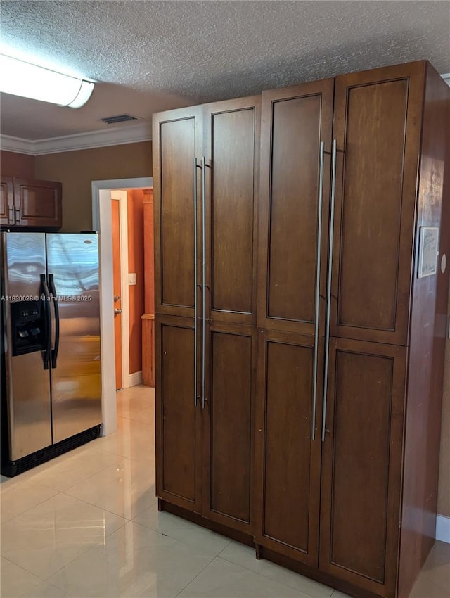 11024 SW 157th Ter, Miami, FL 33157 - kitchen featuring stainless steel refrigerator with ice dispenser, crown molding, a textured ceiling, light tile patterned floors, and dark brown cabinetry