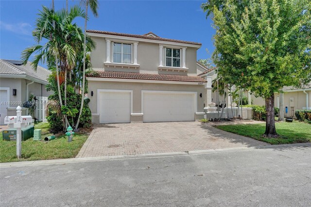 5347 SW 32nd Ter, Hollywood, FL 33312 - mediterranean / spanish home with stucco siding, a tile roof, a garage, and decorative driveway