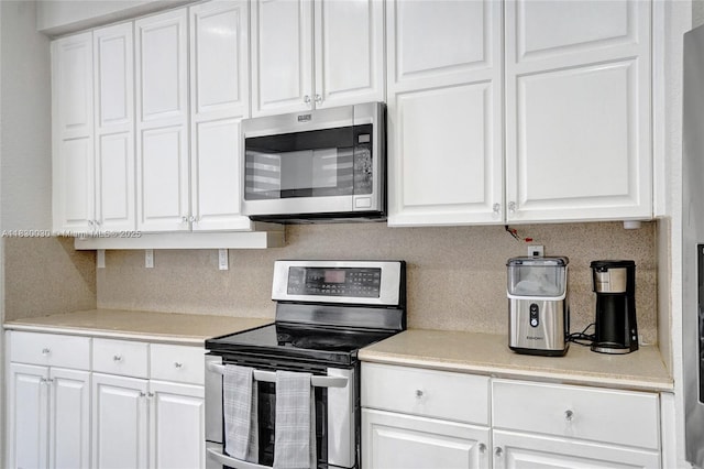 5347 SW 32nd Ter, Hollywood, FL 33312 - kitchen featuring appliances with stainless steel finishes, decorative backsplash, white cabinets, and light countertops