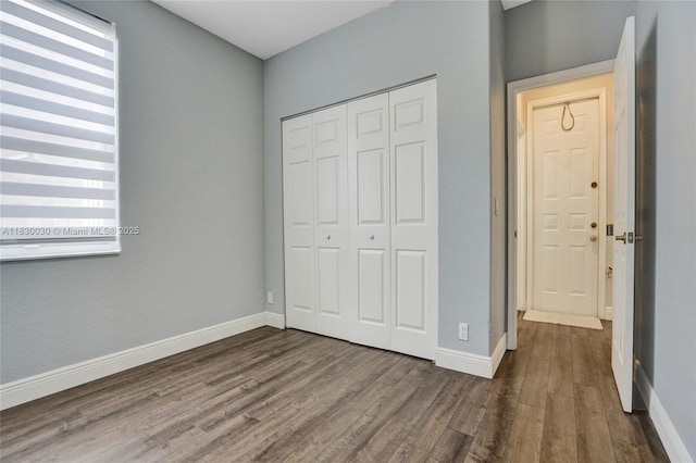 5347 SW 32nd Ter, Hollywood, FL 33312 - unfurnished bedroom featuring dark wood-type flooring, a closet, and multiple windows
