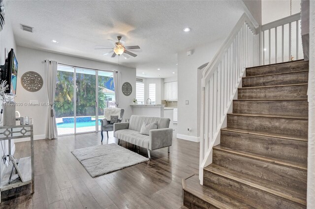 5347 SW 32nd Ter, Hollywood, FL 33312 - living area with ceiling fan, a textured ceiling, stairway, dark wood-type flooring, and recessed lighting