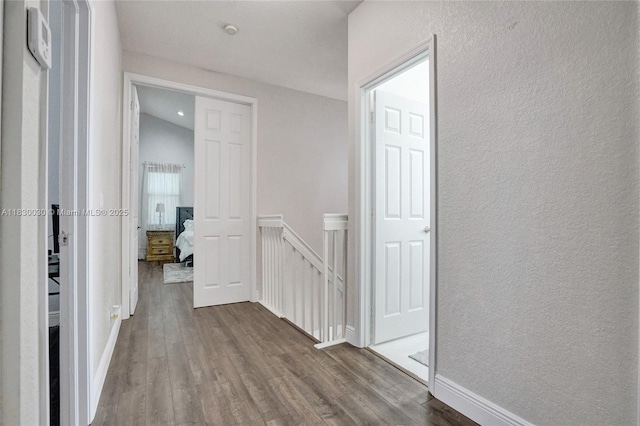 5347 SW 32nd Ter, Hollywood, FL 33312 - corridor featuring an upstairs landing, dark wood-type flooring, and a textured wall