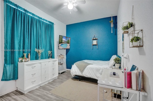 5347 SW 32nd Ter, Hollywood, FL 33312 - bedroom featuring an accent wall, wood finished floors, and a ceiling fan